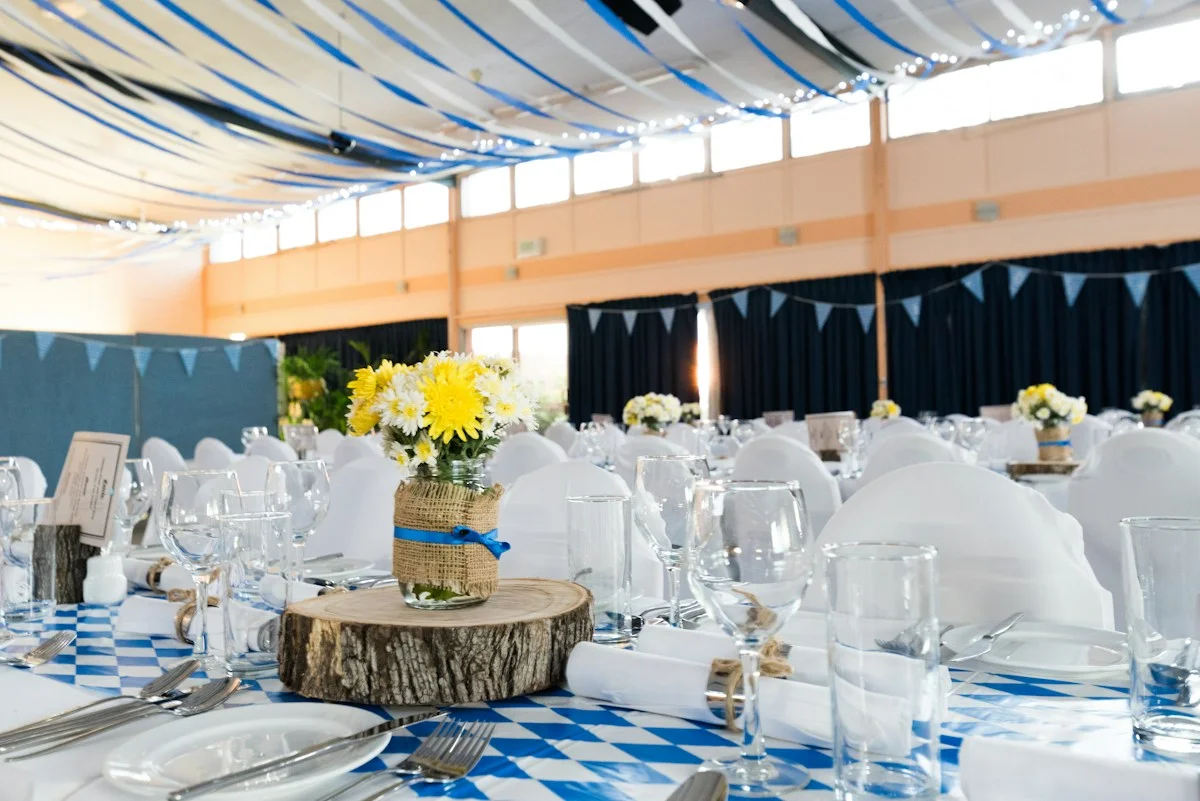 A decorated reception table with floral centrepieces and glassware